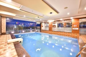 a large swimming pool in a hotel room at Click Hotel Sagar Plaza Chakan, Pune in Chakan