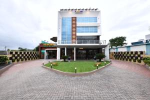 a building with a lawn in front of it at Click Hotel Sagar Plaza Chakan, Pune in Chakan