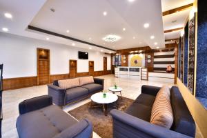 a living room with couches and a table at Click Hotel Sagar Plaza Chakan, Pune in Chakan