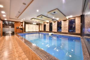 a large swimming pool in a building at Click Hotel Sagar Plaza Chakan, Pune in Chakan