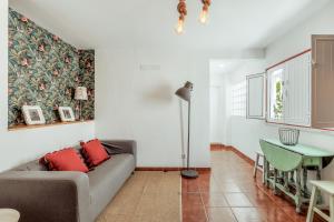 a living room with a couch and a table at Pinheirinha Guest House in Alpiarça