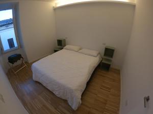 Postel nebo postele na pokoji v ubytování Colonia Iulia