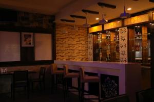 a bar in a restaurant with bar stools at Click Hotel Sagar Plaza Chakan, Pune in Chakan