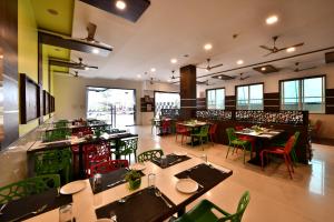 a restaurant with tables and chairs in a room at Click Hotel Sagar Plaza Chakan, Pune in Chakan