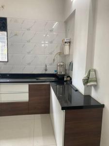 a kitchen with a sink and a counter top at Secluded Serenity in Central Pune:Your Second home in Pune