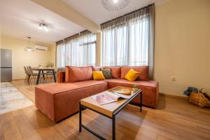 a living room with a couch and a table at Three Lilies Apartments in Plovdiv