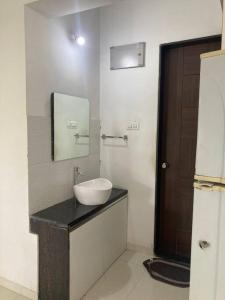 a bathroom with a sink and a mirror at Secluded Serenity in Central Pune:Your Second home in Pune