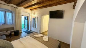 a bedroom with a bed and a tv on a wall at Central garden apartments in Braşov