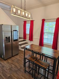 a dining room with a table and a refrigerator at Daydream by The Atlanta Beltline Trail in Cabbagetown in Atlanta