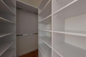 a white walk in closet with white shelves at The presidential studio in Bratislava