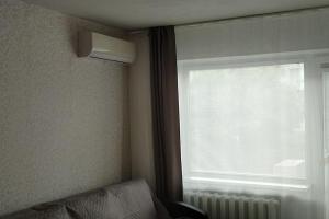 a room with a window with a radiator and a window with a window blind at ShortStopPasilaiciai in Vilnius