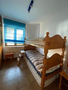 a bedroom with a bunk bed and a window at Sierra Nevada 2-bedroom apartment, nice view in Monachil