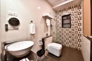 a bathroom with a sink and a toilet at Click Hotel Sagar Plaza Chakan, Pune in Chakan