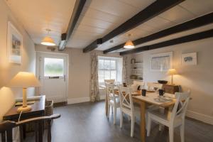 a dining room with a table and chairs at April Cottage in Saint Just in Roseland