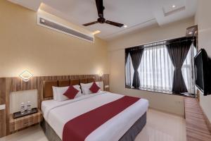 a bedroom with a large bed and a television at Click Hotel Sagar Plaza Chakan, Pune in Chakan