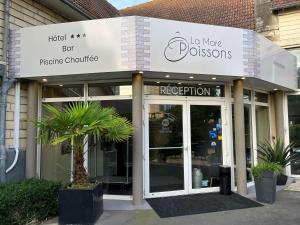 a store front with a sign for a store at Hotel Best Western La Mare Ô Poissons in Ouistreham
