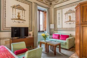 a living room with a couch and a tv at Palazzo Catalani Resort in Soriano nel Cimino