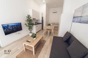 a living room with a couch and a table at Santa Maria de la cabeza2 Apartments in Madrid