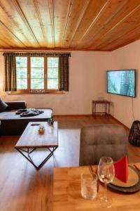 a living room with a couch and a table at Peacefull Mountains View in Kandersteg +21 photos