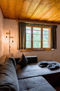 a living room with a couch and two windows at Peacefull Mountains View in Kandersteg