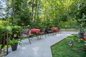 a group of tables and chairs in a garden at Opus Villa in Sinaia