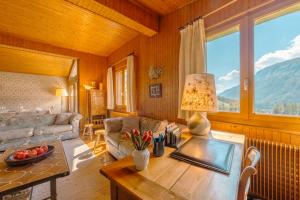 a living room with a couch and a table at Chalet Corzelet ski in - ski out - Happy Rentals in Chamonix