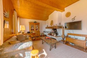 ein Wohnzimmer mit einem Sofa und einem Tisch in der Unterkunft Chalet Corzelet ski in - ski out - Happy Rentals in Chamonix-Mont-Blanc
