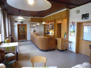 a restaurant with a counter and a table and chairs at Landgasthof Lüder in Lüder