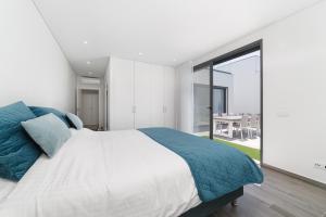 una camera da letto con un letto grande e una grande finestra di Villa Paraiso - By SCH a São Martinho do Porto Altre 22 foto