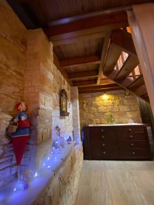 a room with a stone wall with a dresser in it at Lofitiko in Lofou