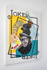 a painting of a joker playing poker at 1BR penthouse with Large Private Terrace in PV by 360 Estates in St. Julianʼs