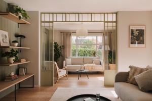 a living room with a couch and a table at Villa Saltic in Grzybowo