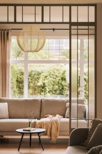 a living room with a couch and a large window at Villa Saltic in Grzybowo