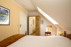 - une chambre avec un grand lit et une lucarne dans l'établissement Feriendorf Papillon Wohnung 10-7, à Boltenhagen