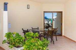 a patio with a table and chairs and plants at Royal Sunset Beach Club in Adeje