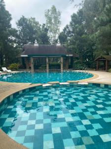 a large swimming pool with a gazebo at Alpine Breeze at Crosswinds Tagaytay in Tagaytay