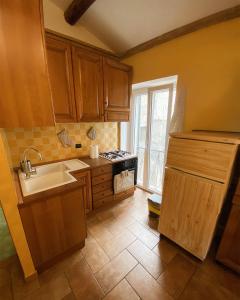 a kitchen with a sink and a stove top oven at Casa del castello in San Vito Romano
