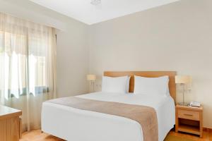 a bedroom with a large white bed and a window at Royal Sunset Beach Club in Adeje
