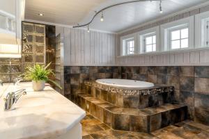 a bathroom with a sink and a tub at Villa Fredheim Farm, Hemsedal in Hemsedal