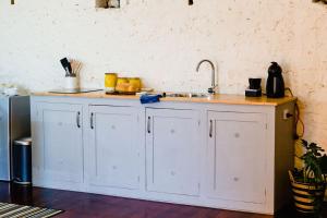 a kitchen with a sink and a counter top at Orange Door Bnb in Currency Creek