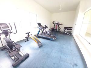 a gym with several exercise equipment in a room at Capital TRUST Residencies Colombo 05 in Colombo