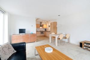 a living room with a couch and a table at Boathouse Suburban Amsterdam in Uitgeest