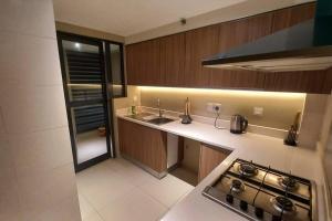 a small kitchen with a stove and a sink at Havelock City Edmonton Tower Colombo 05 in Colombo