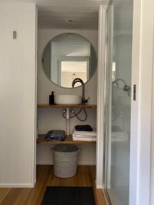 a bathroom with a sink and a mirror at Little Pardalote Tiny Home Bruny Island in Alonnah