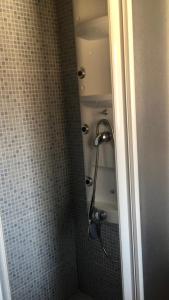 a shower in a bathroom with a tiled wall at Casas rurales lagunas de Ruidera II in Ossa de Montiel