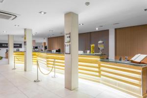 a lobby with a bar with yellow counter tops at Royal Sunset Beach Club in Adeje +36 photos