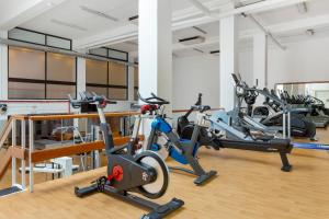 a gym with several cardio machines in a room at Royal Sunset Beach Club in Adeje