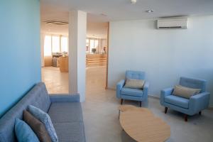 a waiting room with two blue chairs and a table at Royal Sunset Beach Club in Adeje