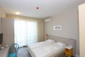 a bedroom with a bed and a large window at Sunny Residence complex in Sunny Beach