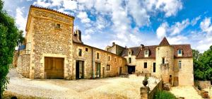 a large stone building with a large tower at Chambres d' hotes Domaine des Mauves in Berbiguières +8 photos